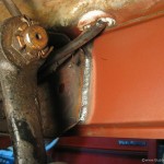Flange welded behind steering arm